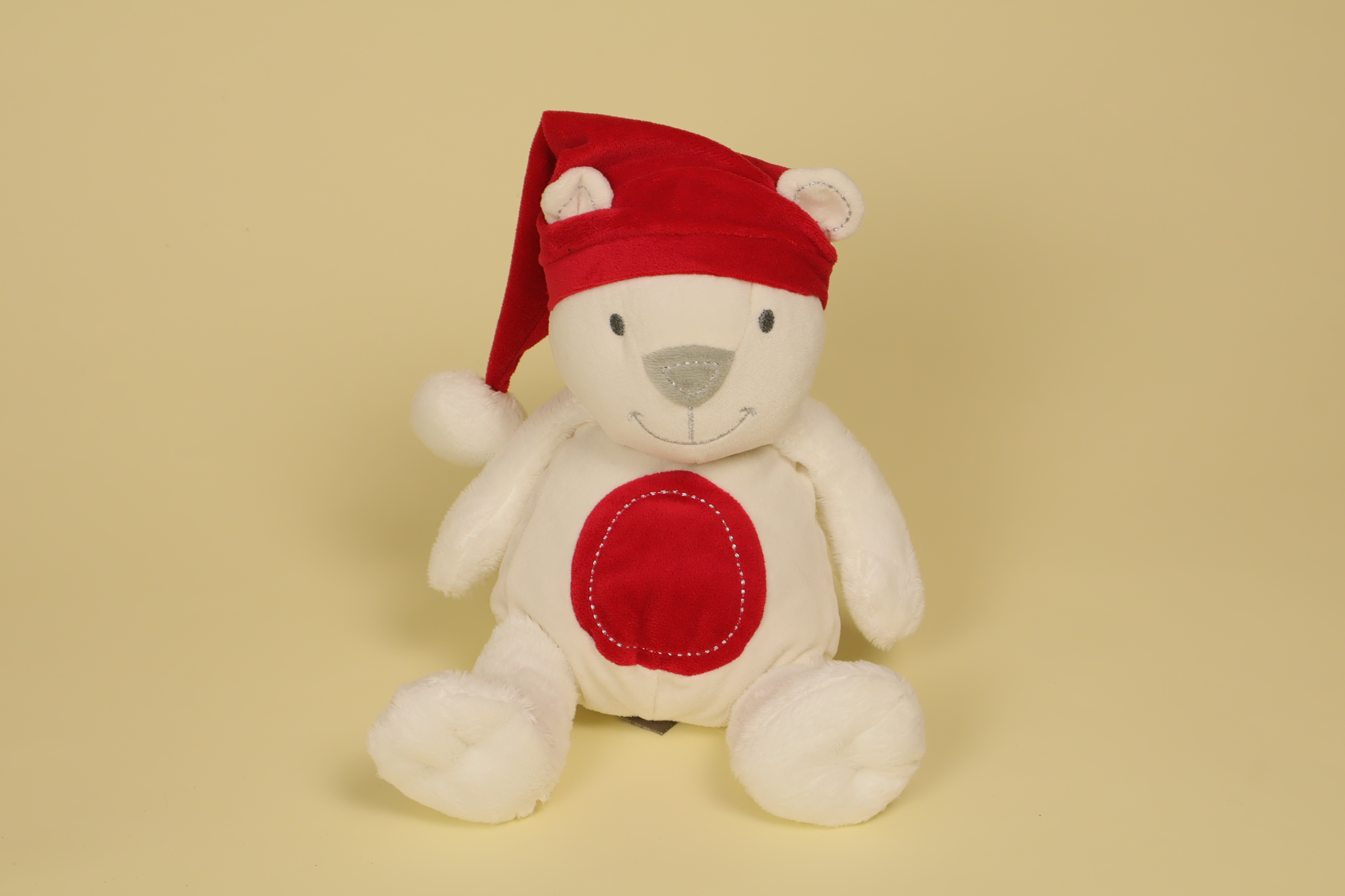 Peluche ours blanc 26 cm avec bonnet rouge de Noël marque Orchestra doudou hiver