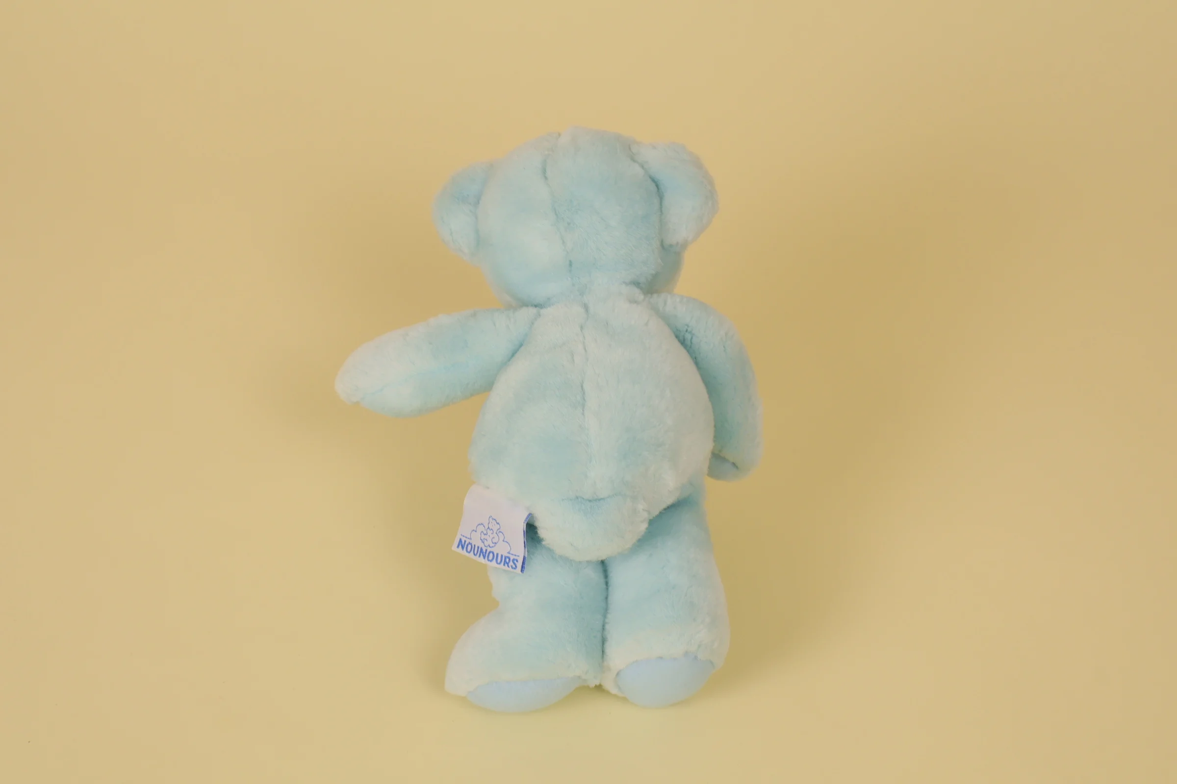 dos Petite peluche ours bleu clair yeux billes marque Nounours 20 cm style classique