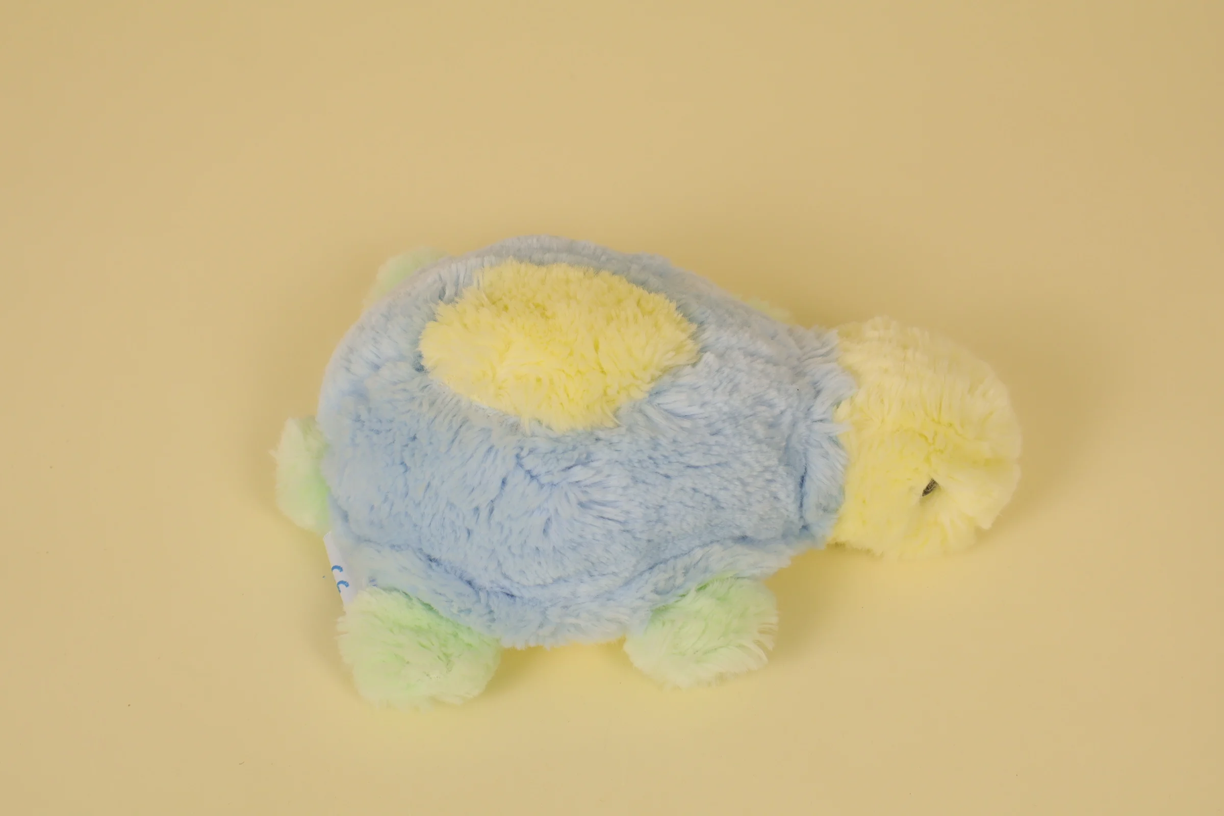 dos Peluche tortue multicolore bleu jaune et vert marque Nounours 23 cm vintage