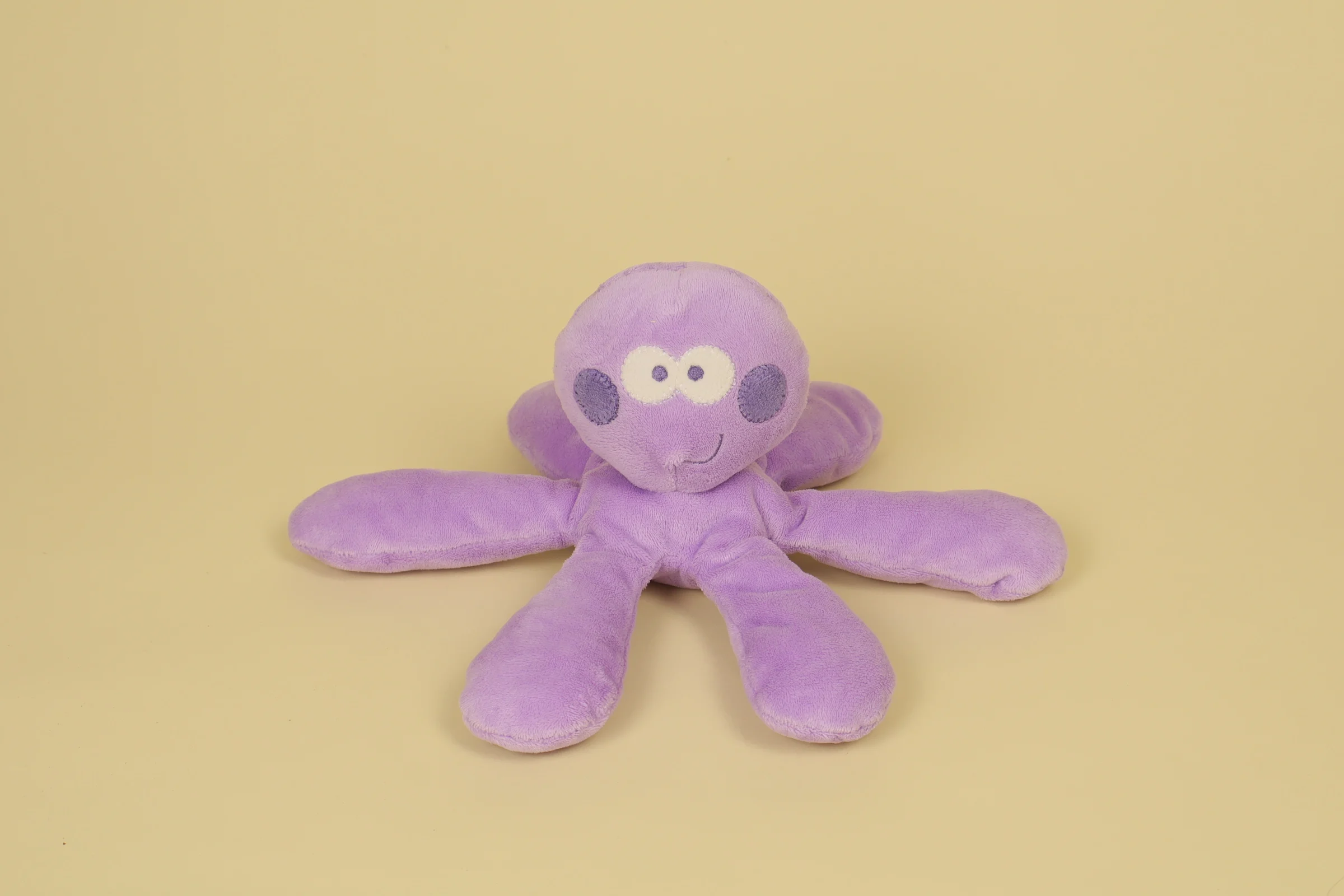 Face Doudou peluche poulpe de couleur parme avec yeux brodés et 6 bras en forme de tentacules souples de la marque Mots d'Enfant