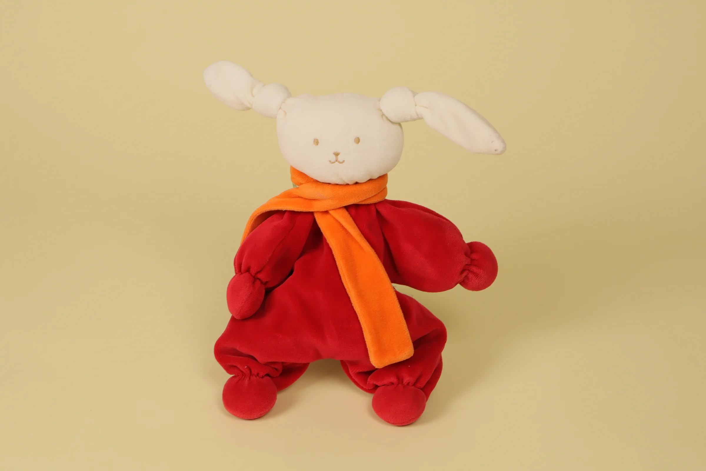 Doudou semi-plat lapin de couleur rouge avec une écharpe orange de la marque Corolle