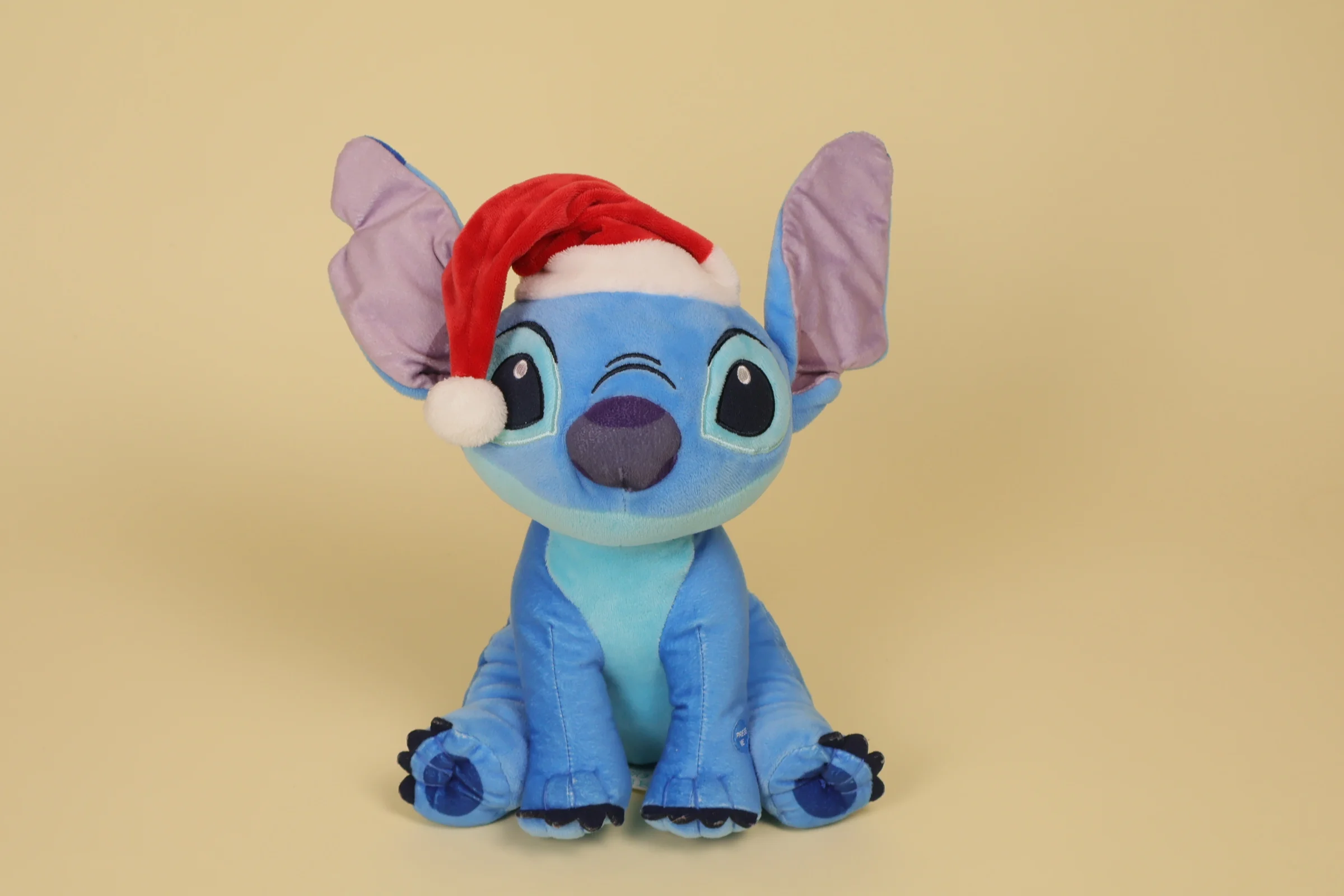 Peluche Stitch bleu sonore de 26 cm avec un bonnet de Noël de la marque Sambro Disney