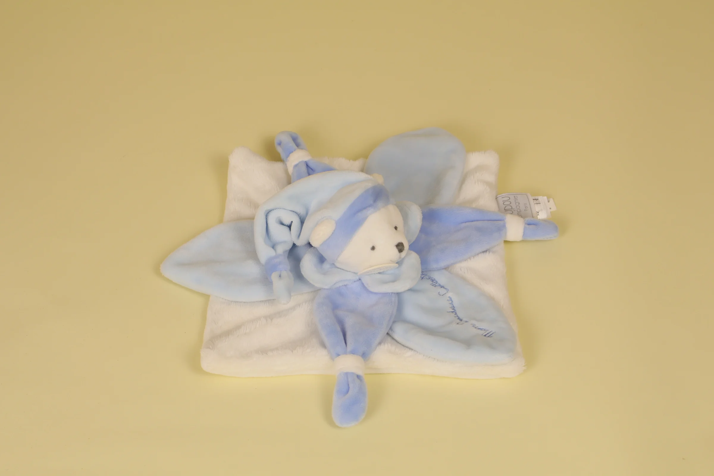 Doudou ours plat blanc avec pétales bleu modèle J'aime mon doudou collection Collector 2017 marque Doudou et Compagnie