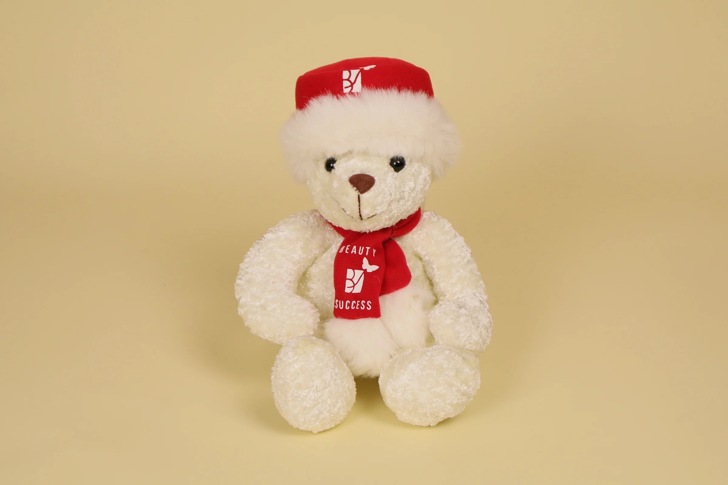 Peluche Ours Blanc avec son bonnet et echarpe rouge pour les 30 ans de l'enseigne Mesure 22 cm Annee 2025 Marque BEAUTY SUCCESS